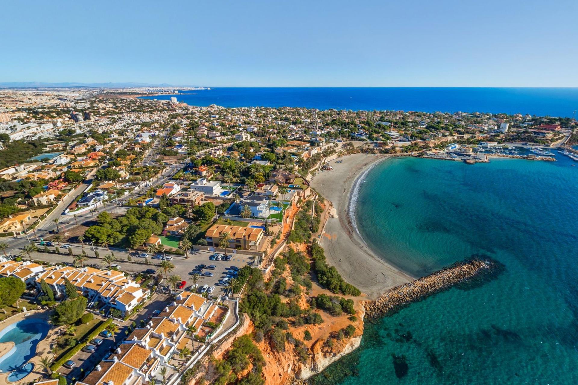 Cabo Roig — Orihuela Costa's most prestigious address — a dramatic rocky headland with cliff walks, a marina, and the finest sea views in the area.