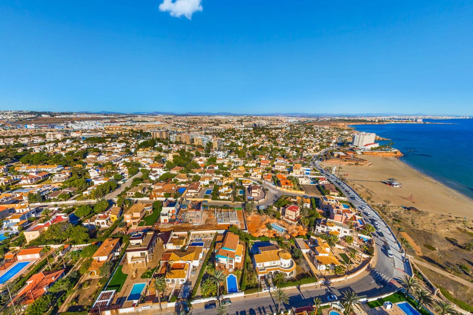 La Zenia — Orihuela Costa's most commercial and family-friendly zone — La Zenia Boulevard, a wide sandy beach, and modern apartment communities.